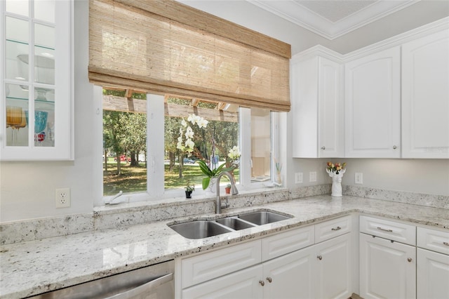 kitchen featuring a sink, dishwasher, white cabinetry, crown molding, and glass insert cabinets