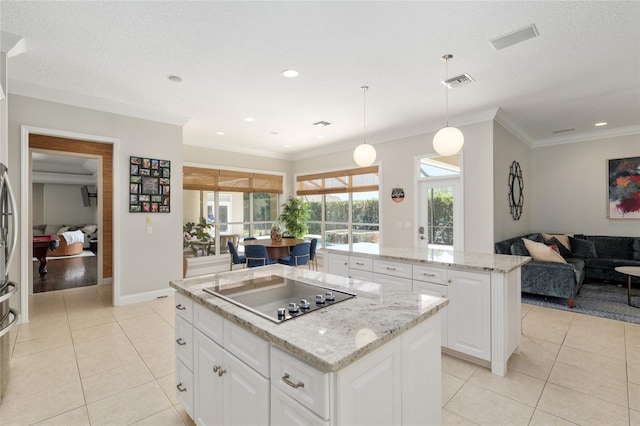 kitchen featuring a kitchen island, black electric cooktop, light tile patterned floors, light stone countertops, and crown molding