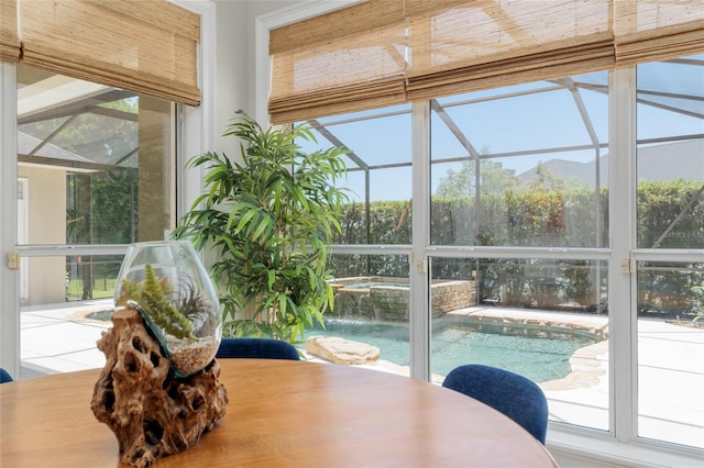 sunroom featuring healthy amount of natural light and a hot tub