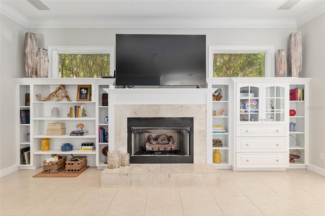 living room featuring crown molding, a fireplace, healthy amount of natural light, and light tile patterned floors