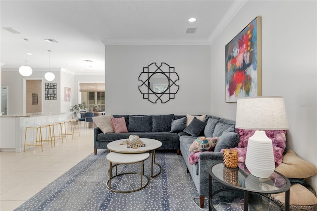 living area with ornamental molding, light tile patterned floors, and recessed lighting