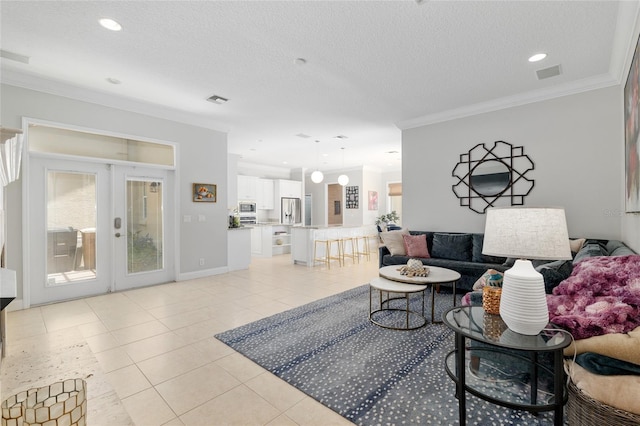 living area with light tile patterned floors, ornamental molding, a textured ceiling, french doors, and recessed lighting