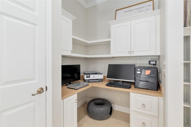 tiled home office with built in desk and crown molding