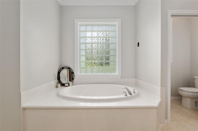 full bath featuring toilet, a bath, and tile patterned floors