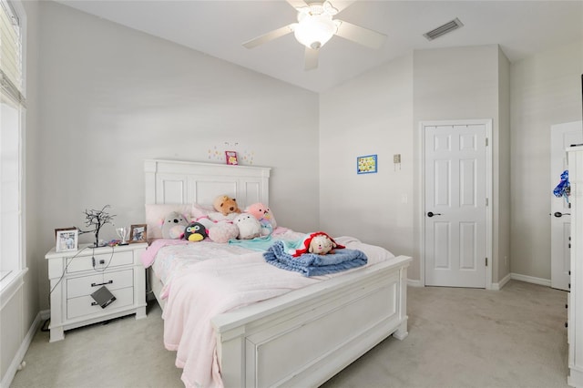 bedroom featuring light colored carpet, baseboards, lofted ceiling, and ceiling fan