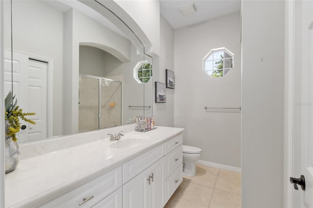 bathroom with a shower stall, toilet, healthy amount of natural light, and vanity