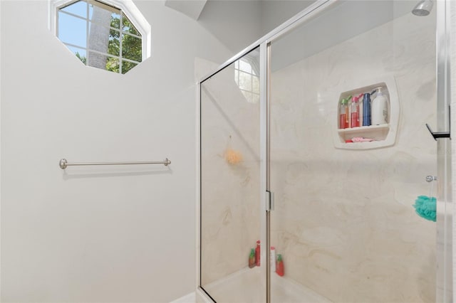 full bathroom with a marble finish shower
