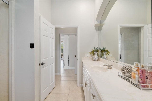 bathroom featuring vanity, tile patterned floors, and baseboards