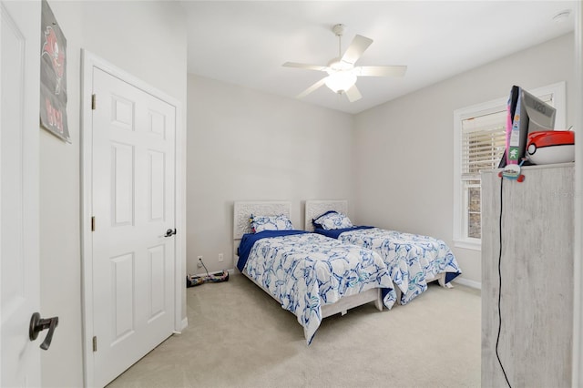 carpeted bedroom featuring a ceiling fan and baseboards