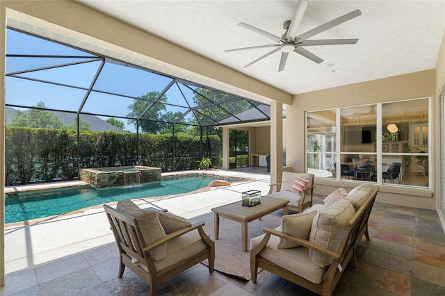 view of swimming pool with a patio, ceiling fan, a pool with connected hot tub, and an outdoor living space