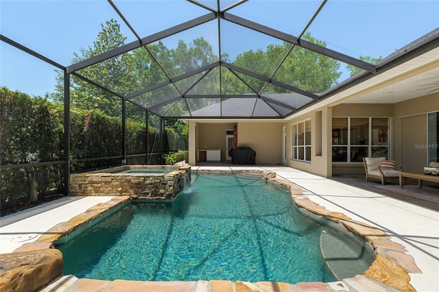 view of swimming pool featuring a patio area, a pool with connected hot tub, and a lanai