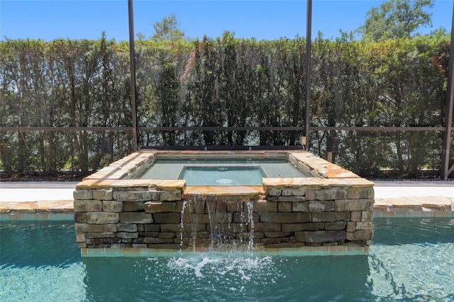 view of swimming pool featuring an in-ground hot tub