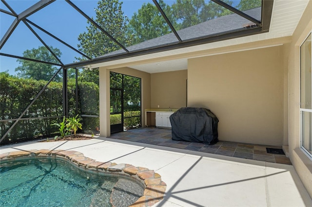 swimming pool with glass enclosure and a patio area