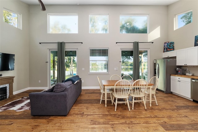 754 SE 167th Court Rd, Silver Springs, FL 34488 - dining space featuring a high ceiling, plenty of natural light, baseboards, and light wood-style flooring