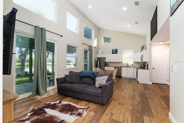 754 SE 167th Court Rd, Silver Springs, FL 34488 - living area with a high ceiling, wood-type flooring, plenty of natural light, and recessed lighting