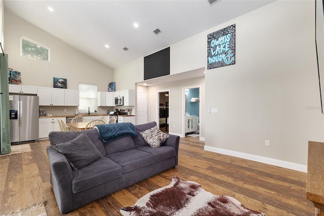 754 SE 167th Court Rd, Silver Springs, FL 34488 - living area featuring high vaulted ceiling, baseboards, wood finished floors, and recessed lighting