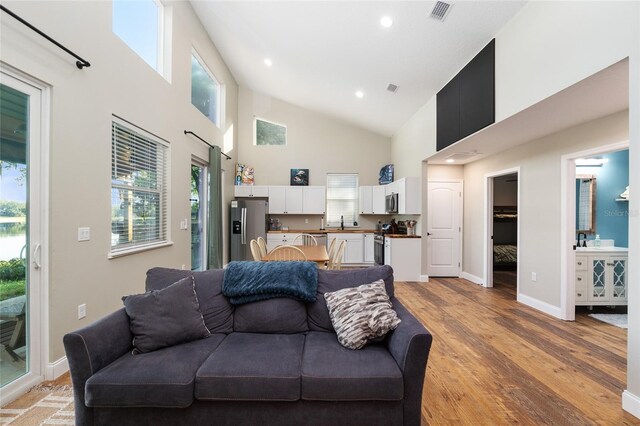 754 SE 167th Court Rd, Silver Springs, FL 34488 - living area featuring high vaulted ceiling, light wood-type flooring, baseboards, and recessed lighting