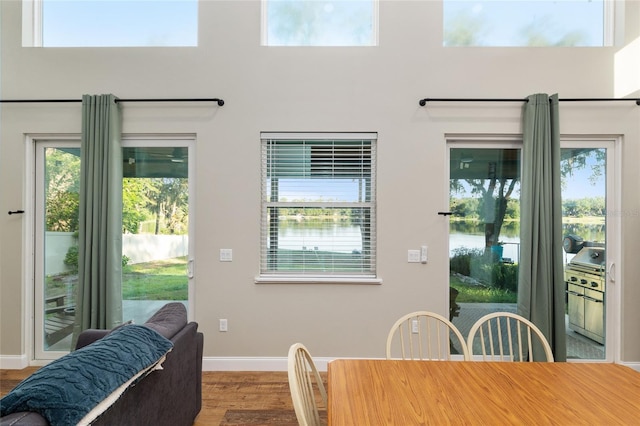 754 SE 167th Court Rd, Silver Springs, FL 34488 - dining area featuring baseboards, wood finished floors, and a water view