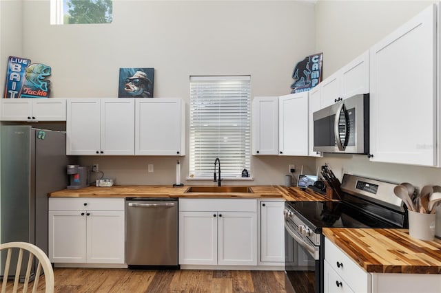 754 SE 167th Court Rd, Silver Springs, FL 34488 - kitchen with butcher block counters, stainless steel appliances, a sink, and plenty of natural light