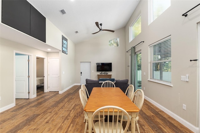 754 SE 167th Court Rd, Silver Springs, FL 34488 - dining area featuring high vaulted ceiling, ceiling fan, baseboards, light wood-style floors, and a barn door