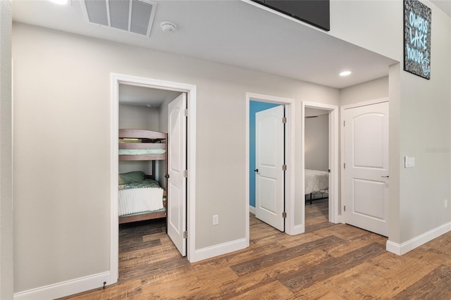 754 SE 167th Court Rd, Silver Springs, FL 34488 - unfurnished bedroom featuring a spacious closet, wood finished floors, baseboards, and recessed lighting