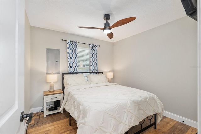 754 SE 167th Court Rd, Silver Springs, FL 34488 - bedroom with baseboards, wood finished floors, and a ceiling fan