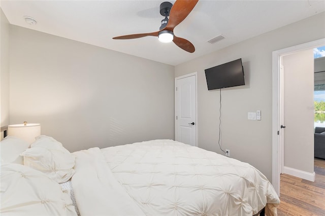 754 SE 167th Court Rd, Silver Springs, FL 34488 - bedroom featuring wood finished floors, baseboards, and ceiling fan