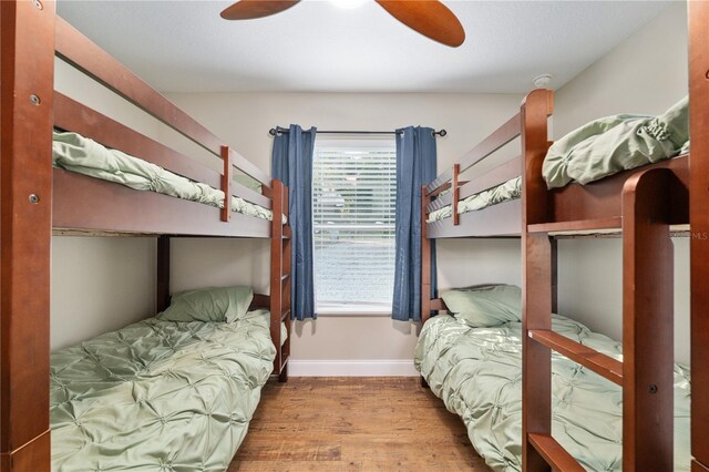 754 SE 167th Court Rd, Silver Springs, FL 34488 - bedroom featuring wood finished floors, multiple windows, baseboards, and a ceiling fan