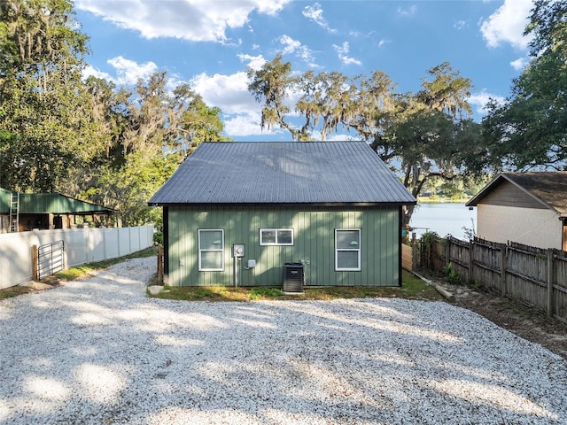 754 SE 167th Court Rd, Silver Springs, FL 34488 - rear view of property with cooling unit, fence, and metal roof