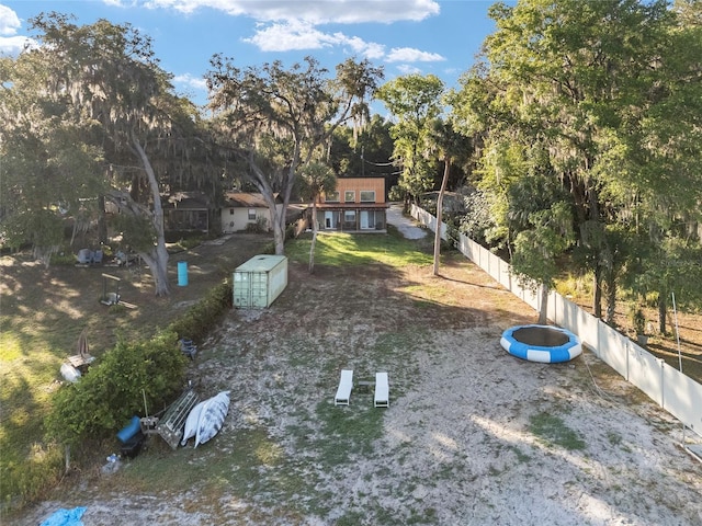 754 SE 167th Court Rd, Silver Springs, FL 34488 - fenced backyard with a storage unit and an outdoor structure