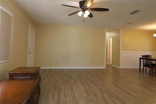 6472 SW 106th Pl, Ocala, FL 34476 - empty room with wood finished floors, ceiling fan, and a chandelier