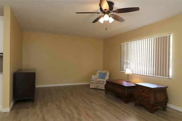 6472 SW 106th Pl, Ocala, FL 34476 - living area featuring ceiling fan, wood finished floors, and baseboards