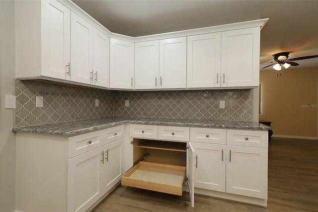 6472 SW 106th Pl, Ocala, FL 34476 - kitchen with white cabinetry, wood finished floors, decorative backsplash, light stone counters, and a ceiling fan