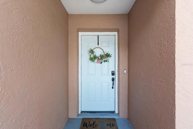 729 Sinclair Ter, Inverness, FL 34450 - doorway to property featuring stucco siding