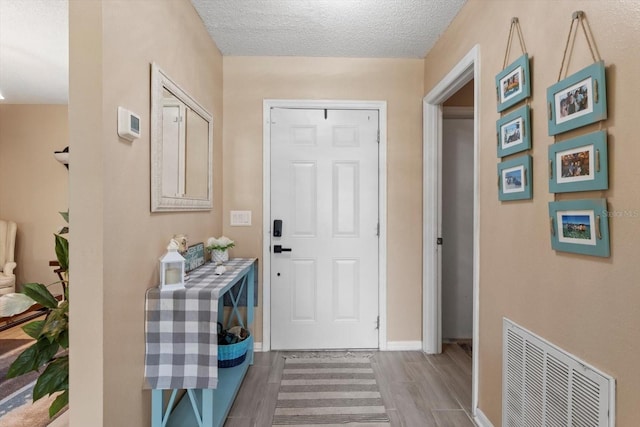 729 Sinclair Ter, Inverness, FL 34450 - entryway featuring wood finished floors, baseboards, and a textured ceiling