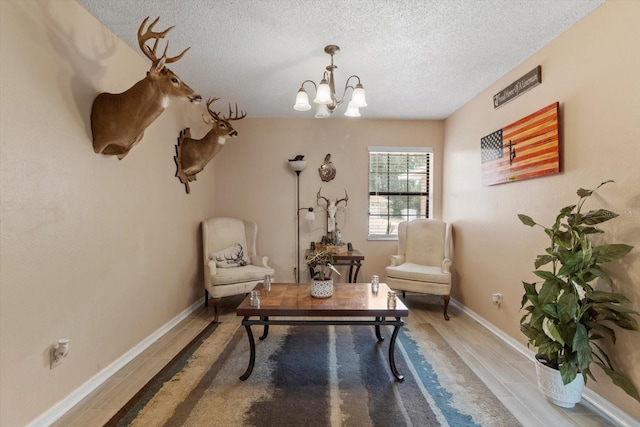 729 Sinclair Ter, Inverness, FL 34450 - living area featuring a chandelier, a textured ceiling, wood finished floors, and baseboards