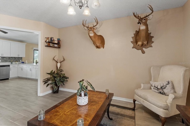 729 Sinclair Ter, Inverness, FL 34450 - living area featuring a chandelier, light wood-type flooring, baseboards, and a textured ceiling