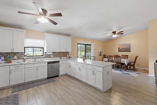 729 Sinclair Ter, Inverness, FL 34450 - kitchen with stainless steel dishwasher, a ceiling fan, a sink, tasteful backsplash, and a peninsula