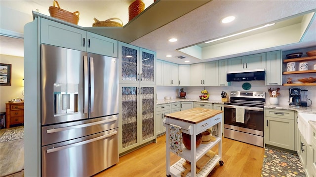 307 N Kinglet Ave, Hernando, FL 34442 - kitchen with stainless steel appliances, ventilation hood, open shelves, a raised ceiling, and butcher block counters