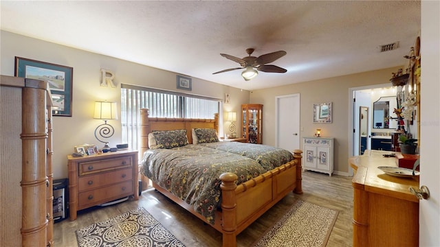 307 N Kinglet Ave, Hernando, FL 34442 - bedroom with light wood-type flooring, a textured ceiling, ceiling fan, and baseboards