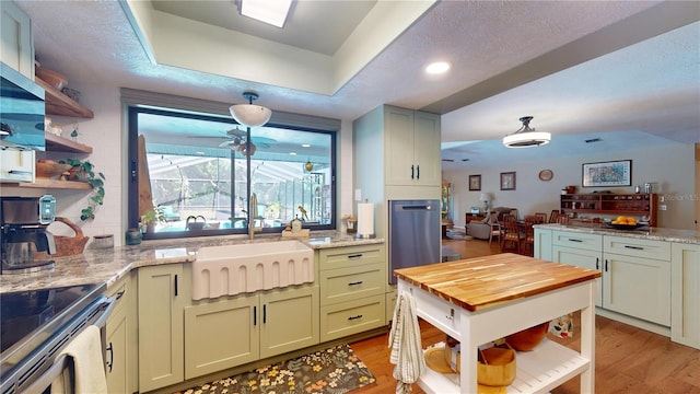 307 N Kinglet Ave, Hernando, FL 34442 - kitchen with open shelves, wood counters, a sink, light wood finished floors, and a raised ceiling