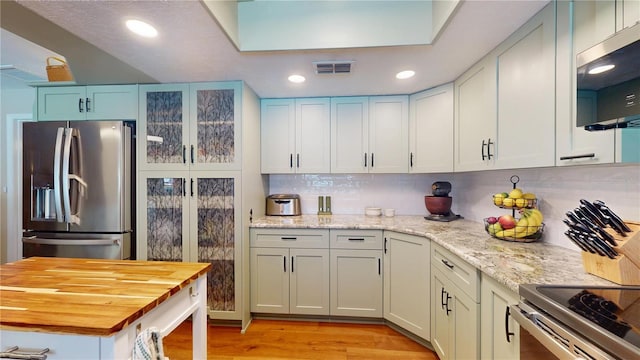 307 N Kinglet Ave, Hernando, FL 34442 - kitchen featuring appliances with stainless steel finishes, light wood finished floors, wood counters, decorative backsplash, and recessed lighting
