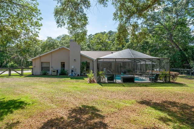 307 N Kinglet Ave, Hernando, FL 34442 - rear view of property featuring a chimney, an outdoor pool, and stucco siding