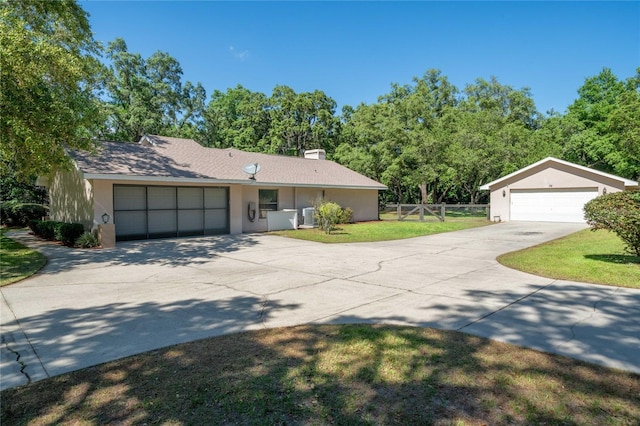307 N Kinglet Ave, Hernando, FL 34442 - view of front of house featuring a chimney, stucco siding, and a detached garage