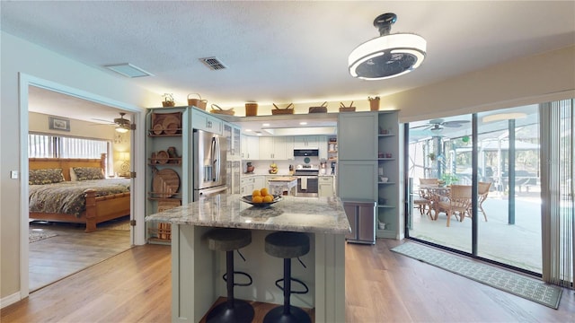 307 N Kinglet Ave, Hernando, FL 34442 - kitchen with open shelves, stainless steel appliances, ceiling fan, and light wood finished floors