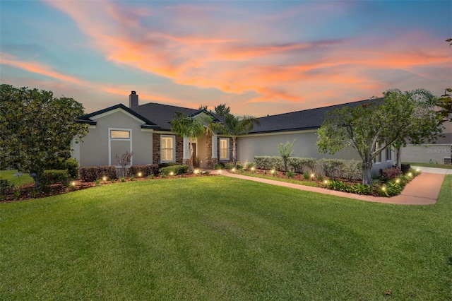 3612 SE 47th Ter, Ocala, FL 34480 - ranch-style home with a chimney, a lawn, stucco siding, and stone siding