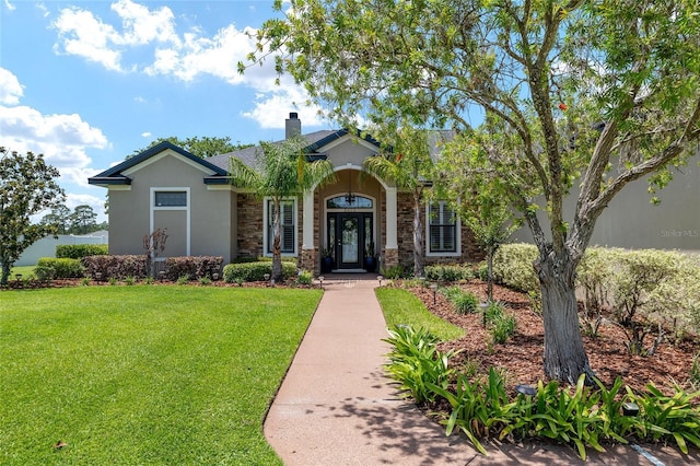 3612 SE 47th Ter, Ocala, FL 34480 - view of front of home with a front yard, a chimney, stucco siding, and stone siding