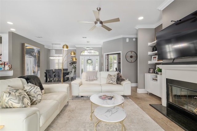 3612 SE 47th Ter, Ocala, FL 34480 - living area featuring a ceiling fan, a glass covered fireplace, ornamental molding, recessed lighting, and baseboards