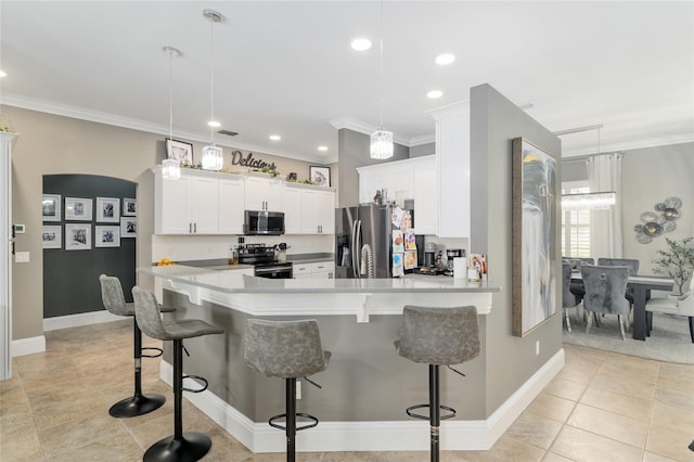 3612 SE 47th Ter, Ocala, FL 34480 - kitchen featuring appliances with stainless steel finishes, a breakfast bar, white cabinets, ornamental molding, and a peninsula
