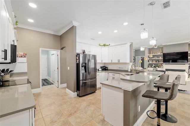 3612 SE 47th Ter, Ocala, FL 34480 - kitchen featuring stainless steel refrigerator with ice dispenser, crown molding, a peninsula, a kitchen breakfast bar, and white cabinets